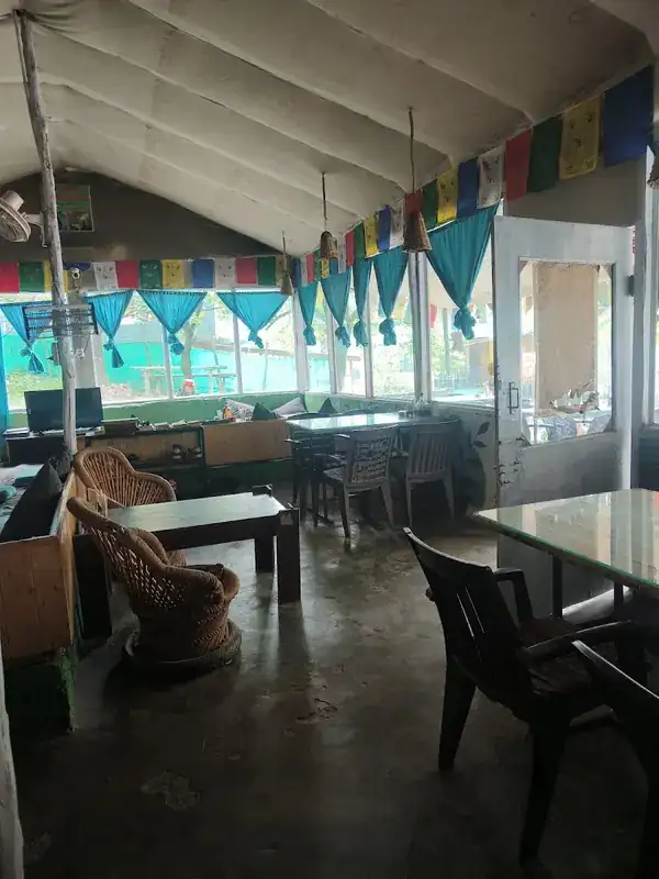 Empty seating before the rush, prayer-flag canopy